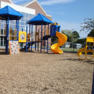 Large commercial playground in school yard. 